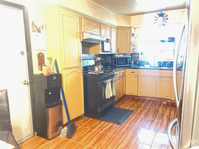 kitchen with appliances with stainless steel finishes and light brown cabinets