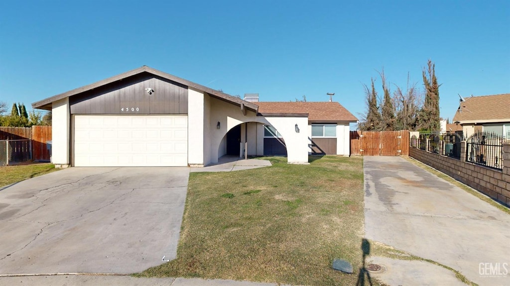 single story home featuring a garage and a front yard