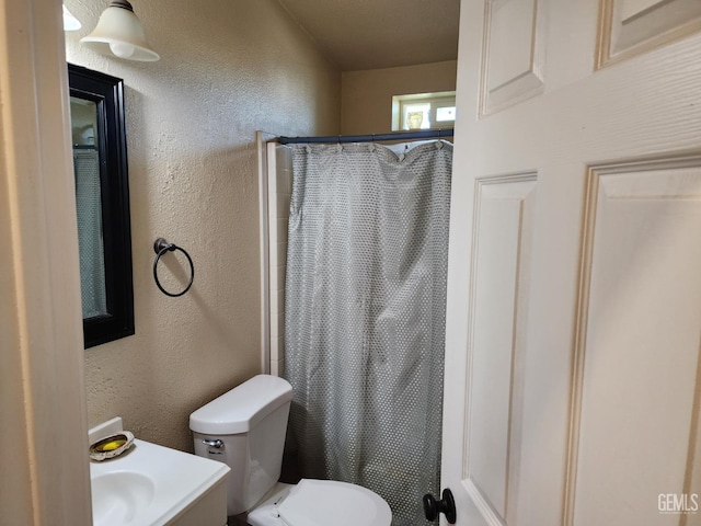 bathroom with toilet and walk in shower