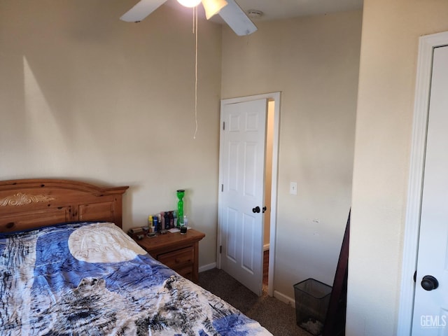 bedroom featuring ceiling fan and dark carpet