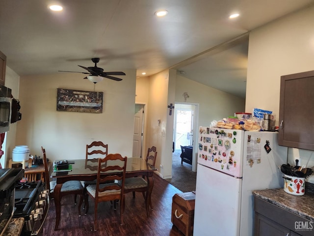 kitchen with vaulted ceiling, dark hardwood / wood-style flooring, white fridge, ceiling fan, and dark brown cabinets