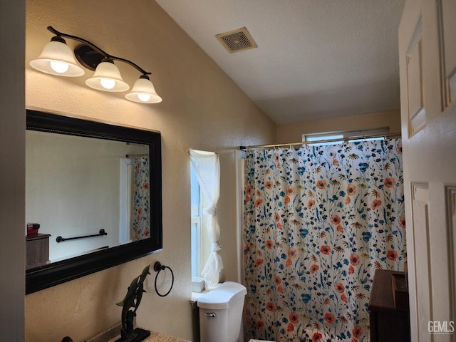 bathroom featuring walk in shower and toilet