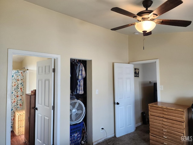 bedroom featuring ceiling fan and dark colored carpet