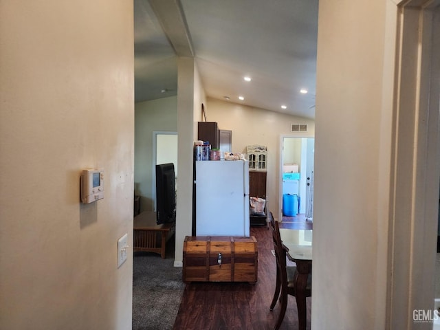 interior space featuring dark wood-type flooring and lofted ceiling