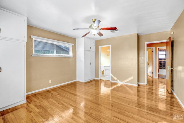 unfurnished room with ceiling fan and light wood-type flooring