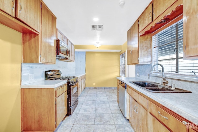 kitchen featuring sink, light tile patterned floors, stainless steel appliances, and tasteful backsplash