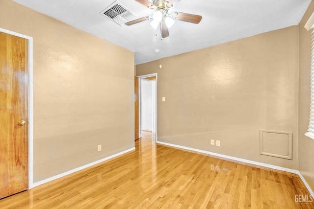 empty room featuring ceiling fan and light wood-type flooring