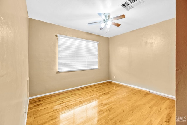 spare room featuring light wood-type flooring and ceiling fan