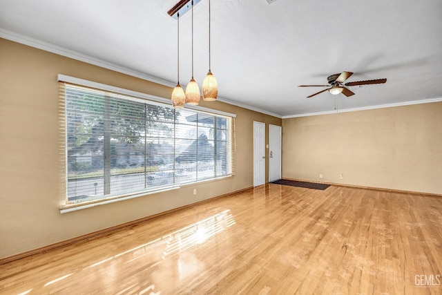 interior space with ceiling fan, a healthy amount of sunlight, and ornamental molding