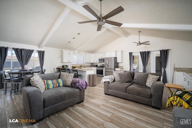 1109 Bell Ave, Taft, CA 93268 - living area featuring a ceiling fan, beam ceiling, light wood-style floors, high vaulted ceiling, and a textured ceiling