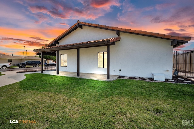 1109 Bell Ave, Taft, CA 93268 - rear view of property featuring a patio area, stucco siding, and a tiled roof