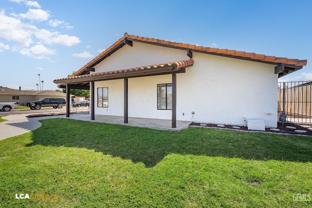 1109 Bell Ave, Taft, CA 93268 - view of side of property featuring a tile roof, stucco siding, and a patio area