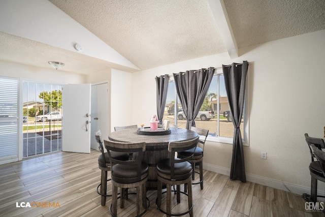 1109 Bell Ave, Taft, CA 93268 - dining room featuring a textured ceiling, light wood-type flooring, and baseboards