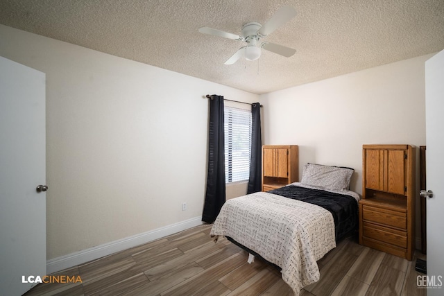 1109 Bell Ave, Taft, CA 93268 - bedroom with a textured ceiling, wood finished floors, baseboards, and ceiling fan