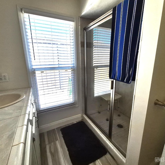 1109 Bell Ave, Taft, CA 93268 - full bathroom with a shower stall, vanity, wood finished floors, and baseboards