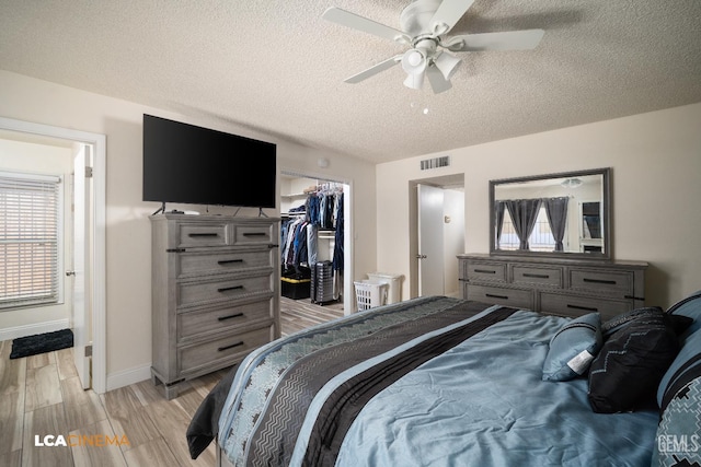 1109 Bell Ave, Taft, CA 93268 - bedroom featuring a textured ceiling, baseboards, light wood-style floors, a spacious closet, and a closet