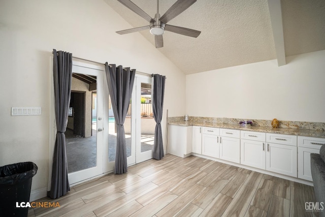1109 Bell Ave, Taft, CA 93268 - kitchen featuring ceiling fan, light wood-style flooring, a textured ceiling, light stone counters, and white cabinets