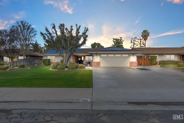 view of front facade with a garage and a lawn