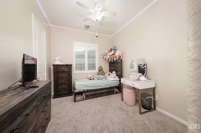 carpeted bedroom with ornamental molding, baseboards, visible vents, and ceiling fan