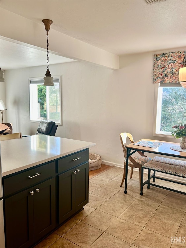 kitchen featuring light tile patterned floors and hanging light fixtures