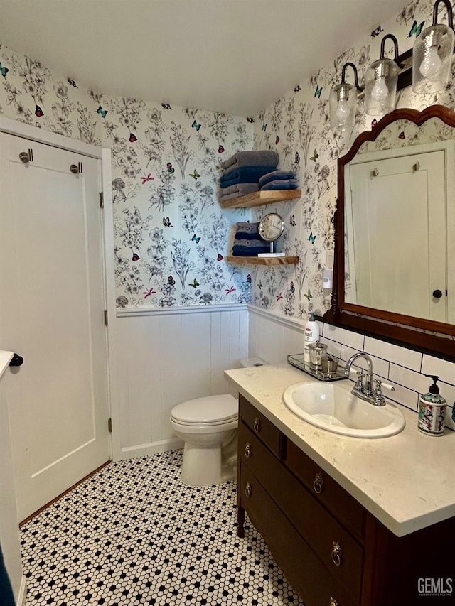 bathroom with toilet and vanity