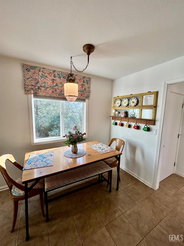 dining room with dark tile patterned floors