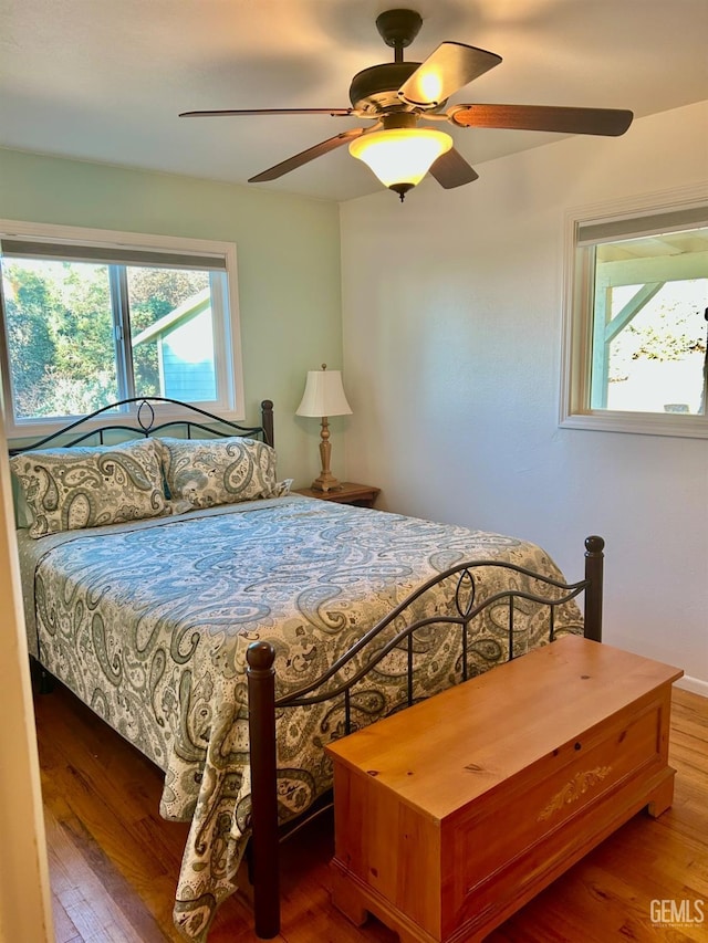 bedroom with ceiling fan and hardwood / wood-style flooring