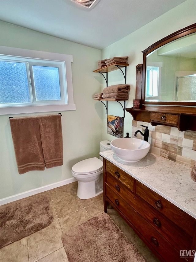 bathroom with toilet, tile patterned floors, and vanity