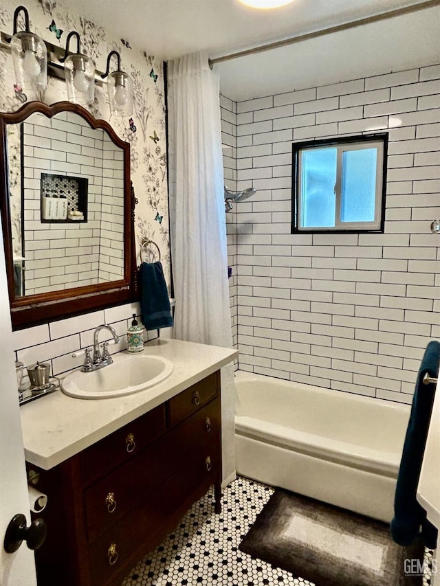 bathroom with tile patterned flooring, shower / bathtub combination with curtain, and vanity