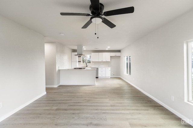 unfurnished living room with a ceiling fan, recessed lighting, light wood-style floors, and baseboards