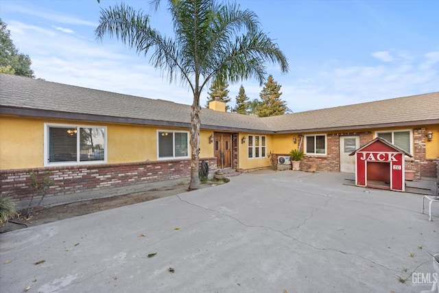 253 E Mckee Rd, Bakersfield, CA 93307 - view of front facade with brick siding, stucco siding, and a chimney