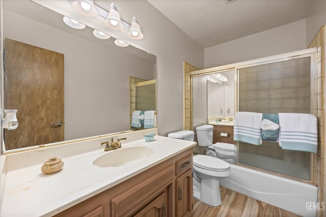 253 E Mckee Rd, Bakersfield, CA 93307 - full bath featuring vanity, combined bath / shower with glass door, and wood finished floors