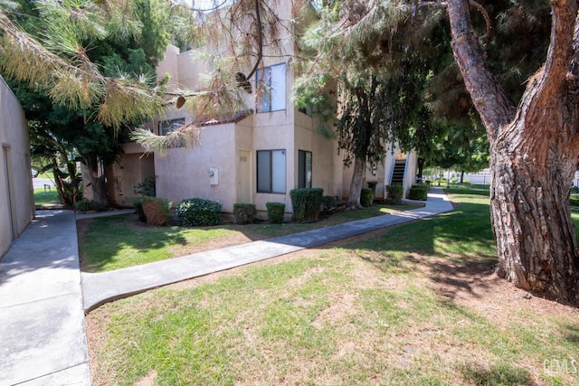 14500 Las Palmas Dr Unit 3, Bakersfield, CA 93306 - view of front facade featuring stucco siding and a front lawn