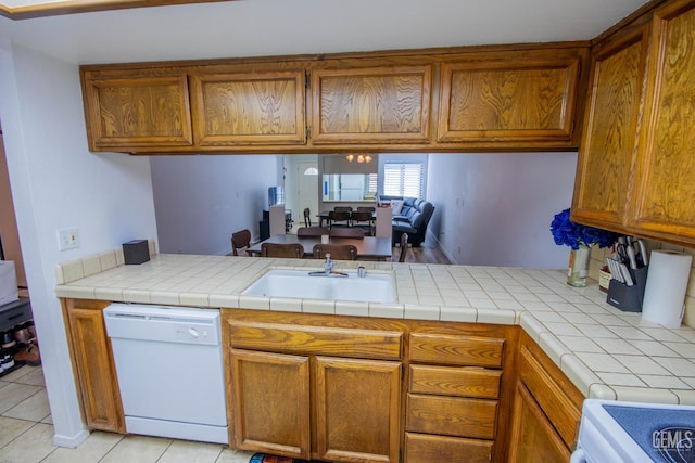 14500 Las Palmas Dr Unit 3, Bakersfield, CA 93306 - kitchen featuring dishwasher, brown cabinetry, range, open floor plan, and light tile patterned floors