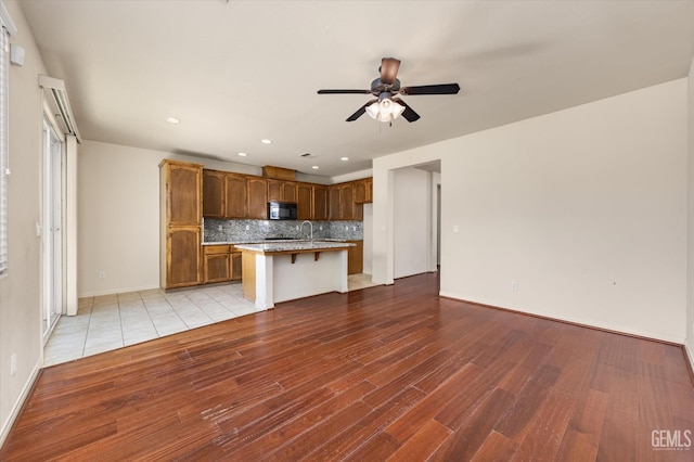9711 Boothbay Harbour Dr, Bakersfield, CA 93314 - kitchen featuring black microwave, tasteful backsplash, wood finished floors, ceiling fan, and recessed lighting
