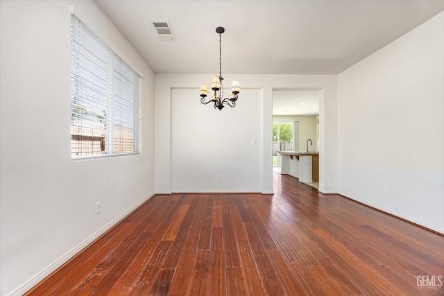 9711 Boothbay Harbour Dr, Bakersfield, CA 93314 - unfurnished room featuring a chandelier, dark wood-style flooring, a sink, and baseboards