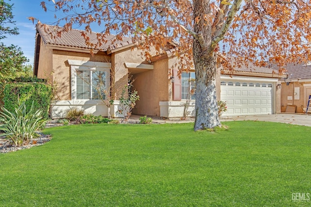 view of front of property featuring a garage and a front lawn