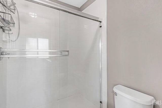 bathroom featuring an enclosed shower and toilet