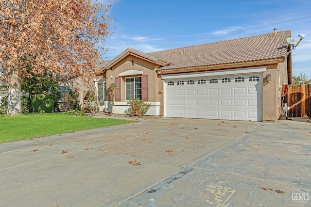 view of front of property featuring a garage and a front lawn