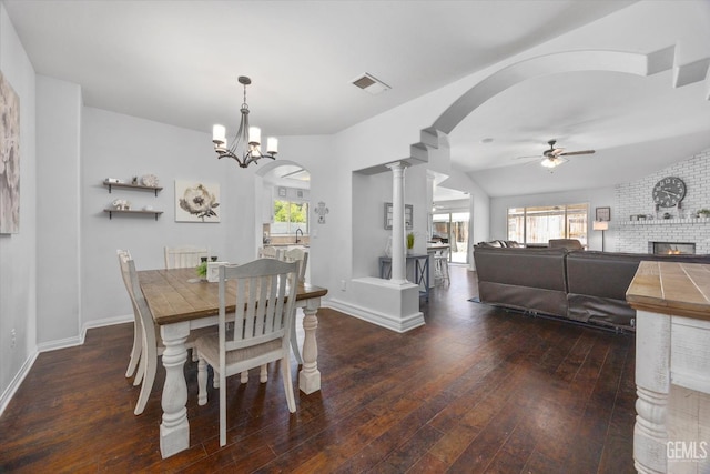 5812 Seasons Valley Ct, Bakersfield, CA 93313 - dining room featuring a ceiling fan, decorative columns, hardwood / wood-style flooring, arched walkways, and a fireplace