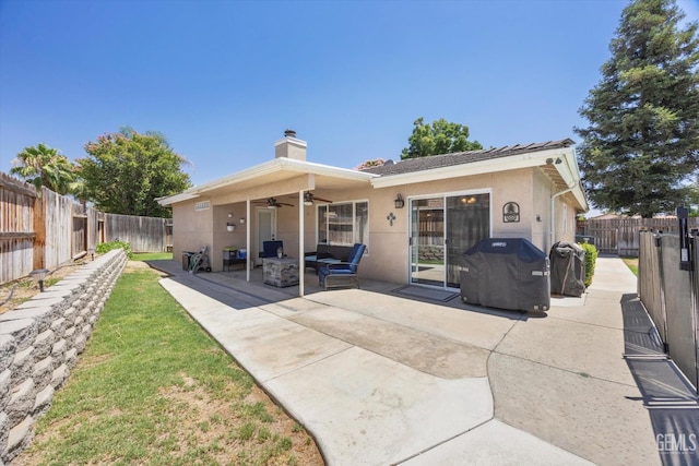 5812 Seasons Valley Ct, Bakersfield, CA 93313 - back of property with a ceiling fan, a patio, a chimney, stucco siding, and a fenced backyard