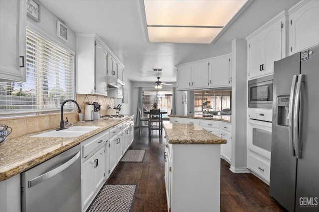 5812 Seasons Valley Ct, Bakersfield, CA 93313 - kitchen featuring appliances with stainless steel finishes, ceiling fan, plenty of natural light, and white cabinets