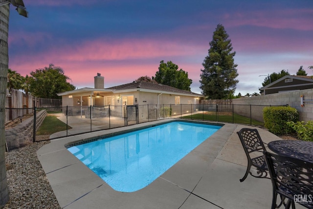 5812 Seasons Valley Ct, Bakersfield, CA 93313 - pool at dusk with a patio area, a fenced backyard, and a ceiling fan