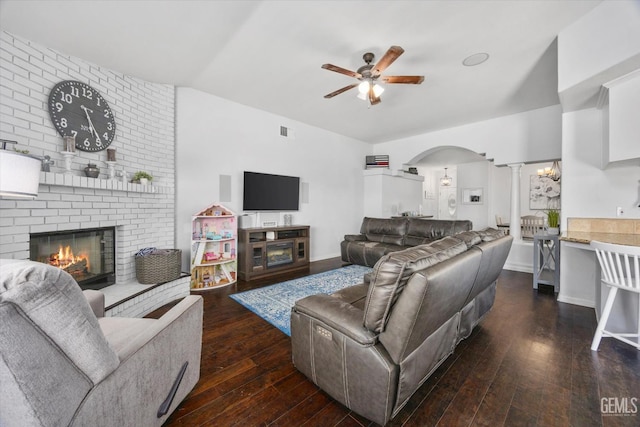 5812 Seasons Valley Ct, Bakersfield, CA 93313 - living room featuring a fireplace, ceiling fan, ornate columns, hardwood / wood-style flooring, and arched walkways