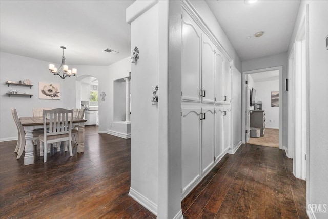 5812 Seasons Valley Ct, Bakersfield, CA 93313 - corridor with dark wood-style flooring, arched walkways, and a chandelier