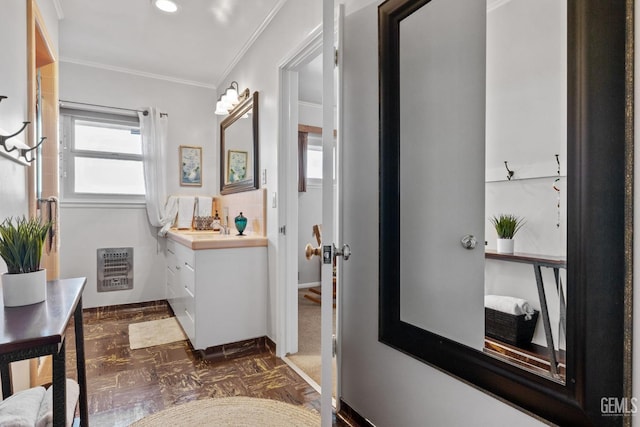 bathroom with vanity, parquet floors, crown molding, and heating unit