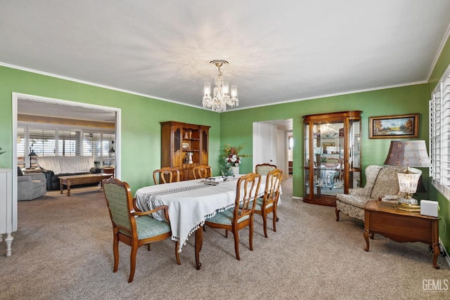 carpeted dining area featuring a chandelier