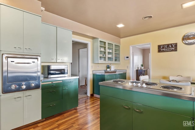 kitchen featuring white cabinets, light wood-type flooring, and appliances with stainless steel finishes