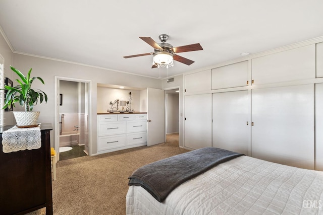 bedroom with light carpet, ceiling fan, ornamental molding, connected bathroom, and a closet