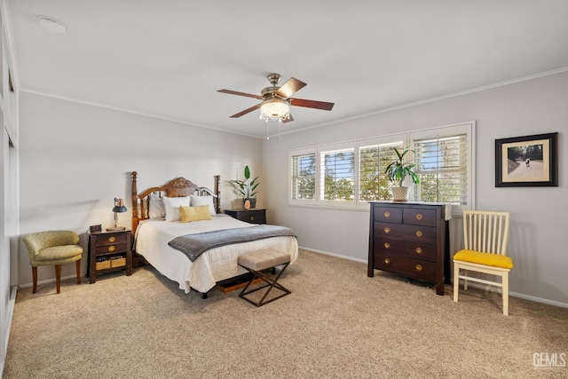 carpeted bedroom featuring ceiling fan and ornamental molding